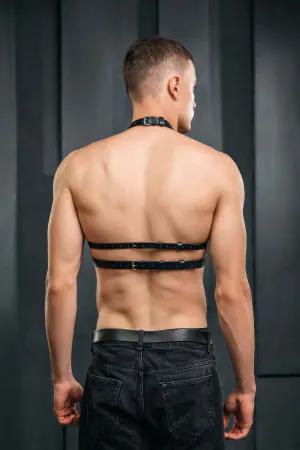 Black faux leather chest harness with O-ring detail and adjustable straps