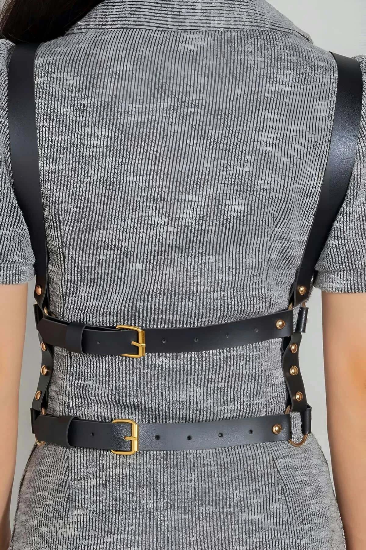 Faux Leather Harness Close-Up Strap Hardware and Stitching in Black with Gold Buckles and Rivets on Back View