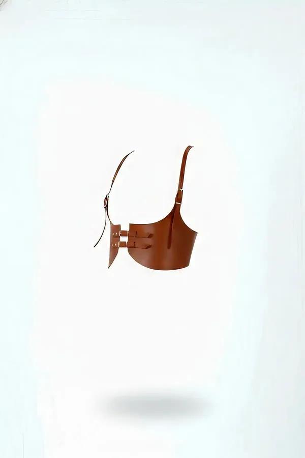 tan faux leather underbust corset harness with triple horizontal slot panel and gold-tone buckle shoulder strap, side view