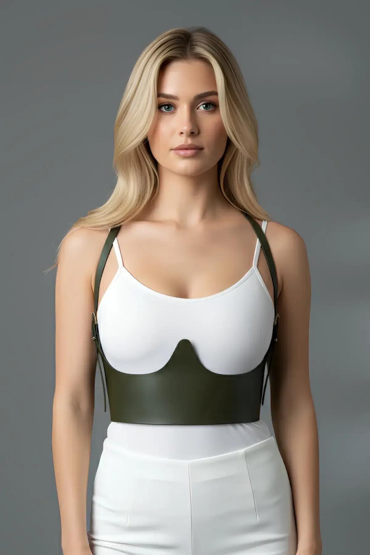 side view of olive underbust harness bustier cinching the waist over a fitted white top