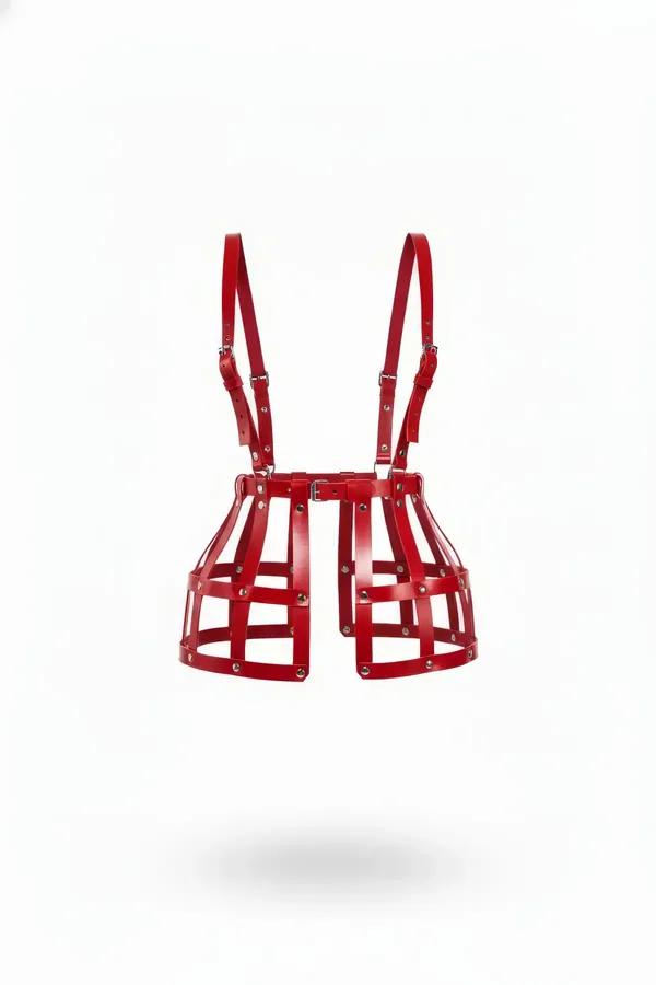 Red faux leather caged waist harness skirt with silver rivets, structured hip cage panels, and adjustable shoulder straps on 