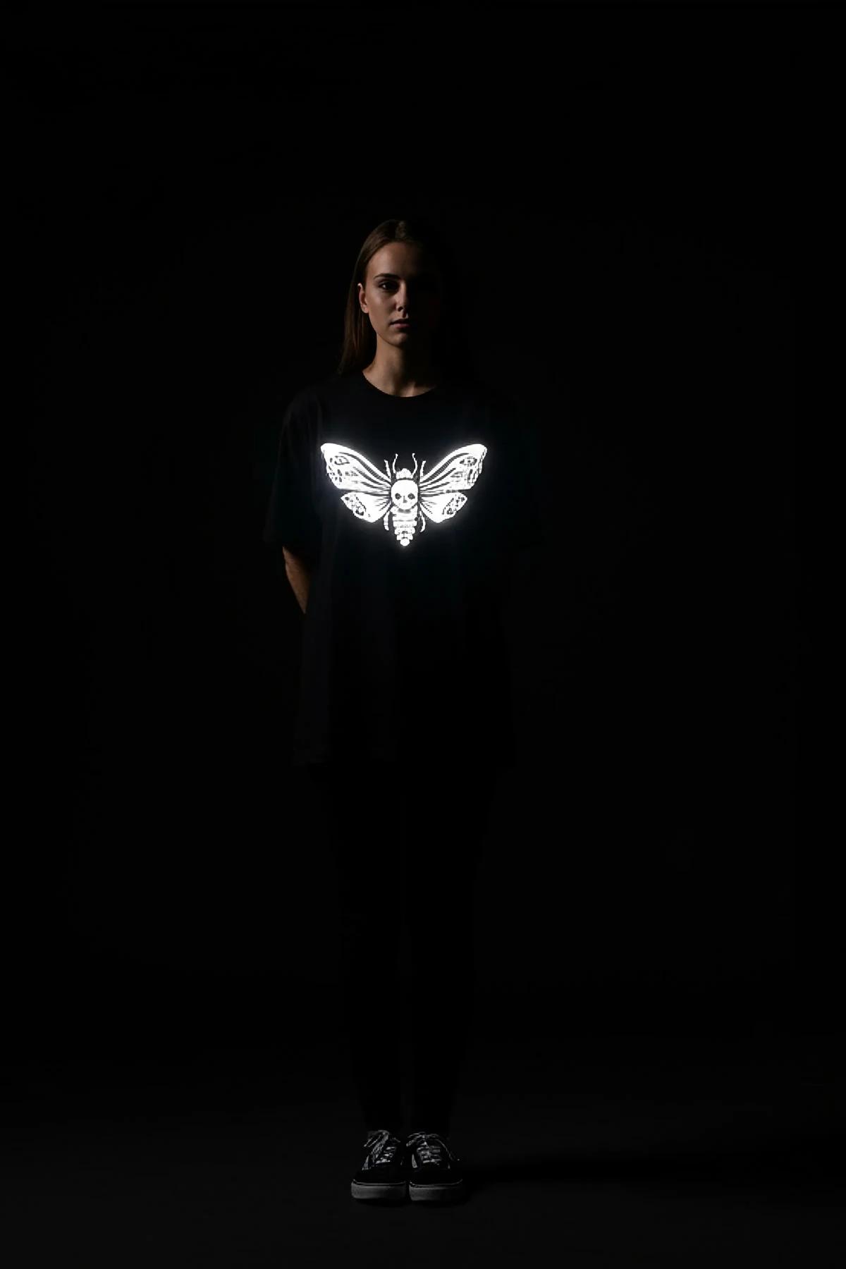 black reflective skull moth graphic t-shirt oversized fit bright white print under direct light