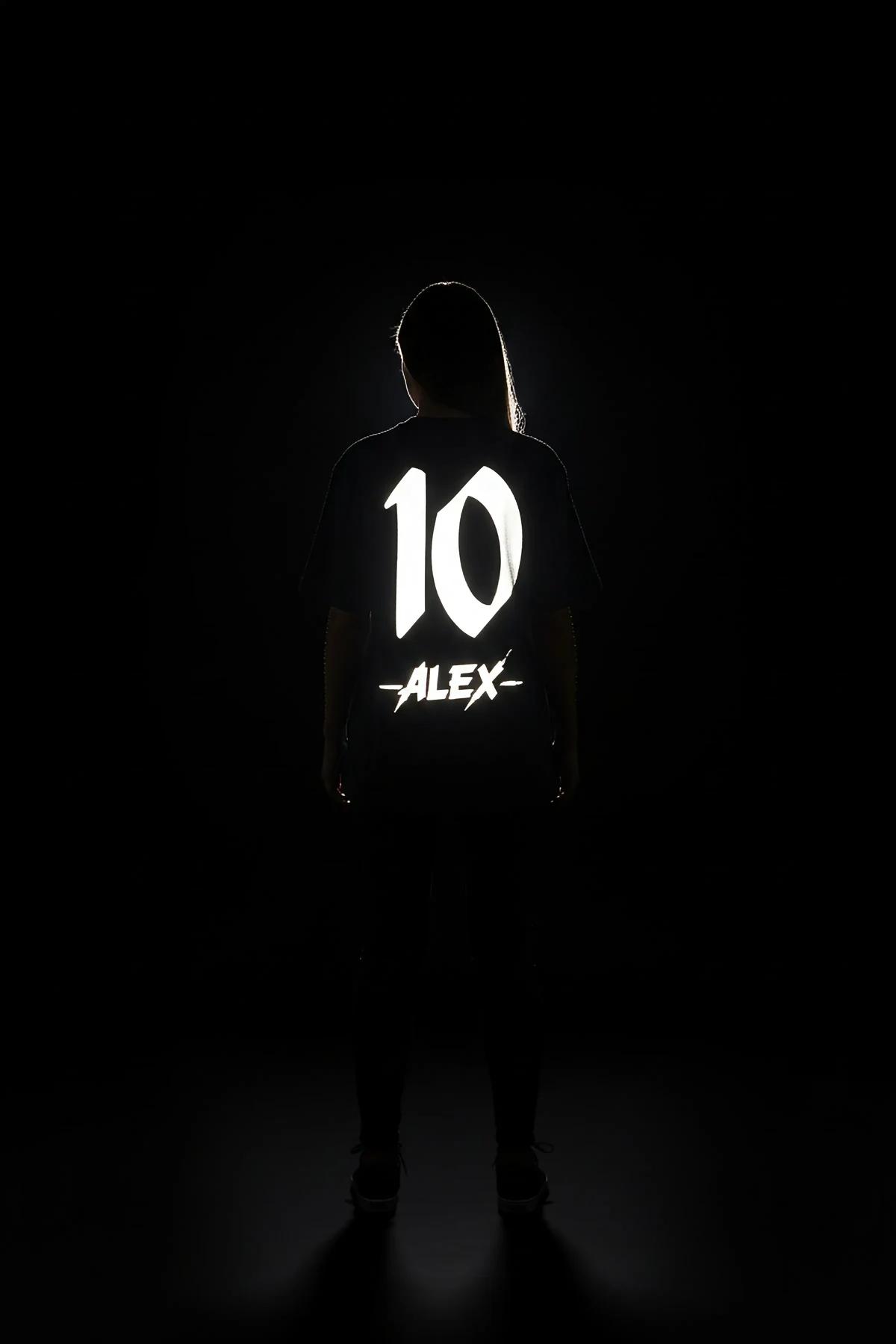 black custom jersey reflective number activating under direct studio lighting