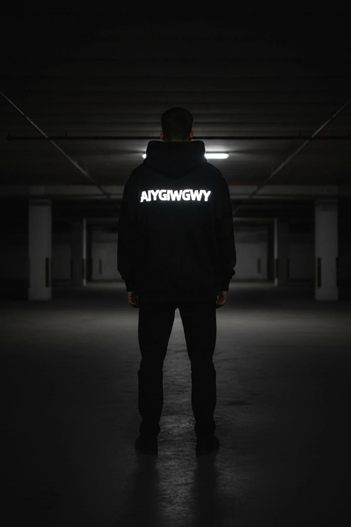 Reflective glow hoodie chest print activated by flashlight in low-light environment