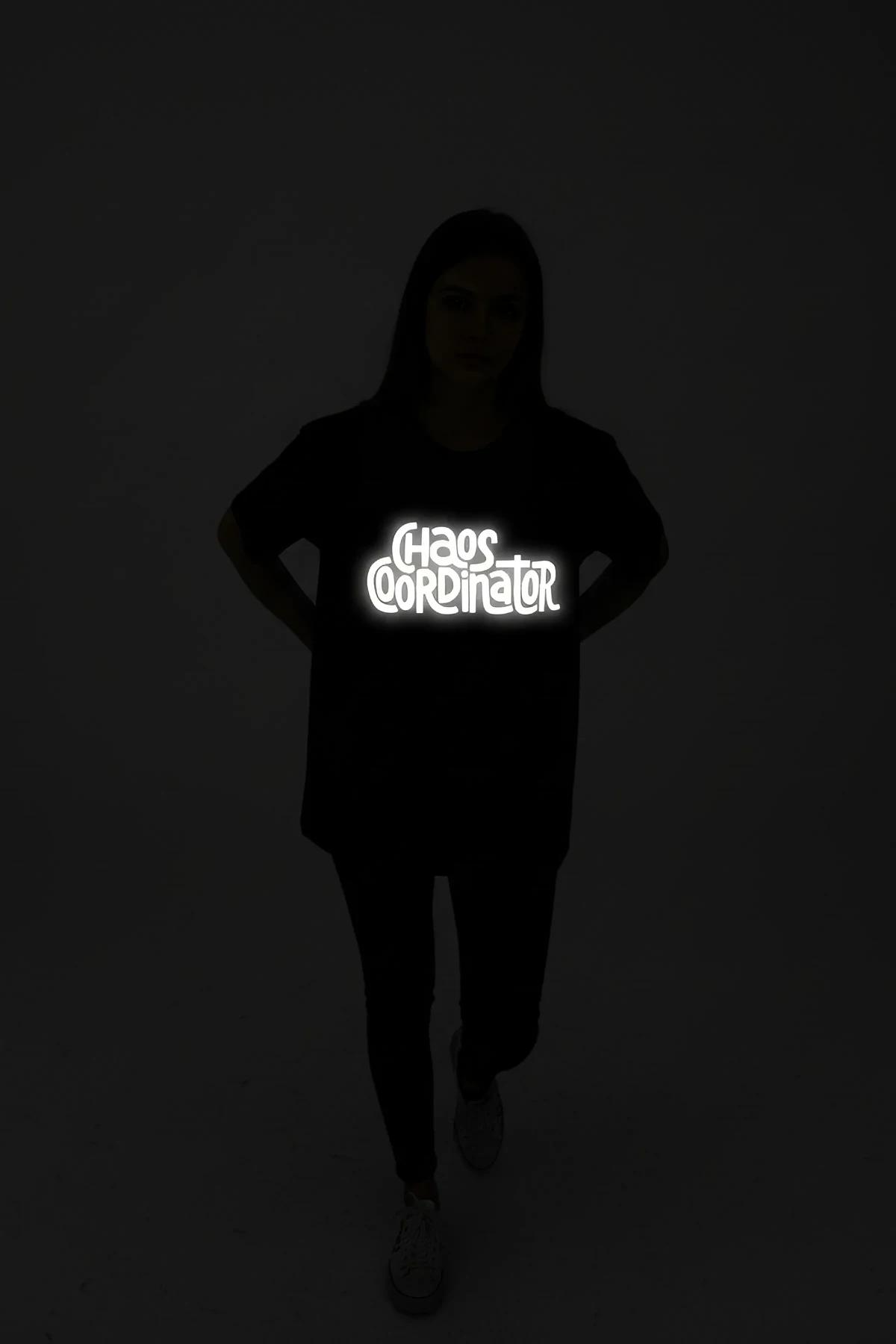 black performance leggings with bold graphic print glowing under low-light studio conditions