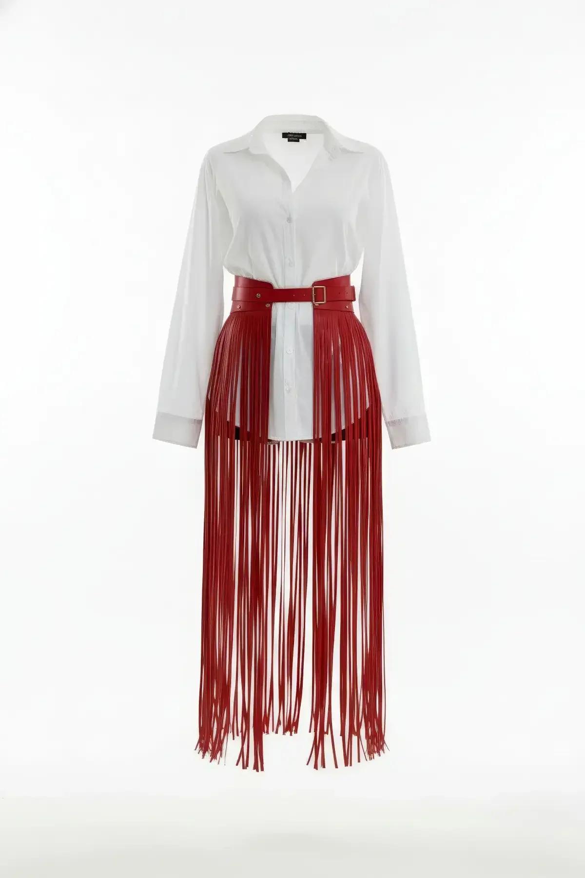 Red faux leather fringe waist harness skirt overlay with gold-tone buckle worn over a white shirt