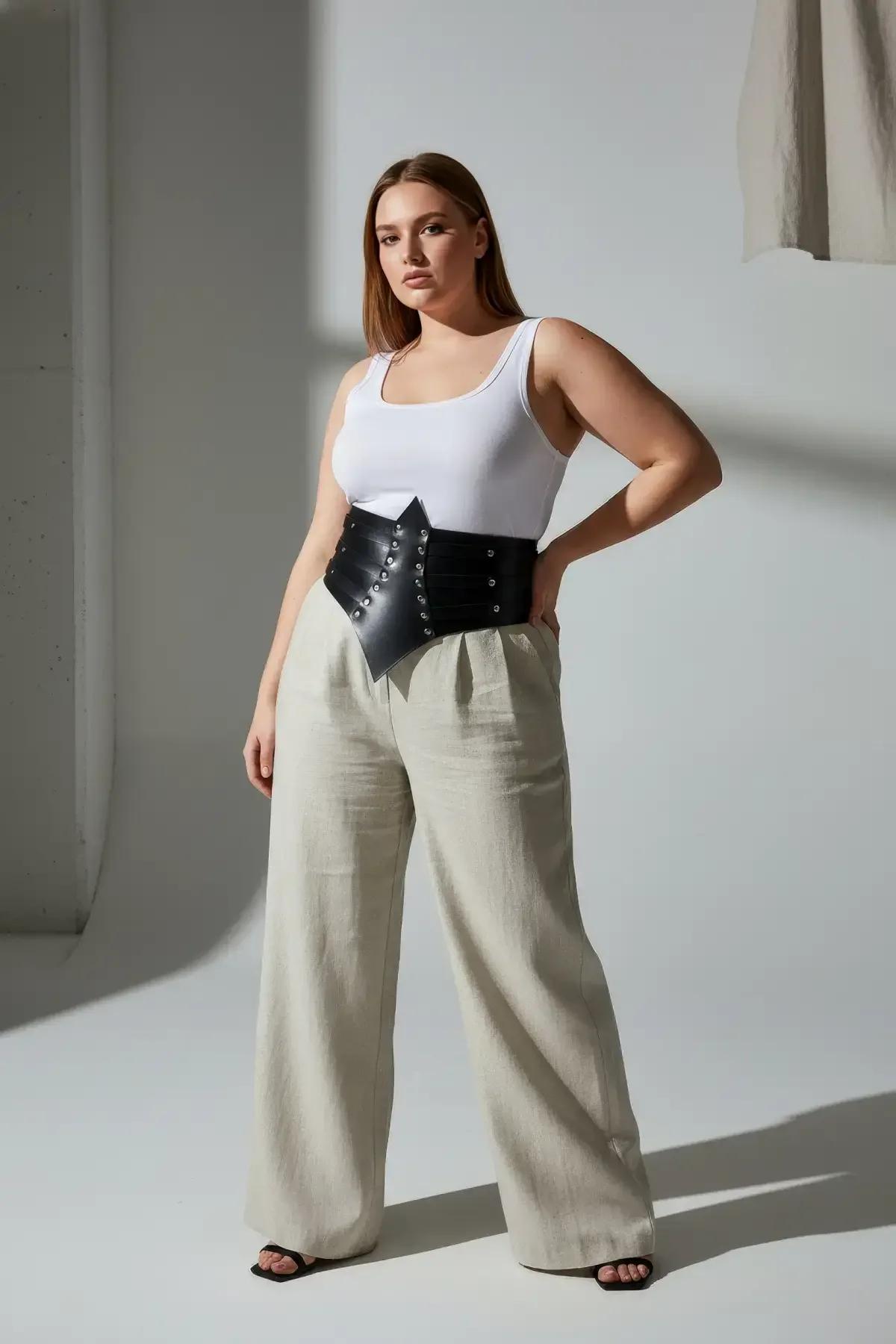 Black waist cincher belt with pointed front styled over wide-leg linen trousers