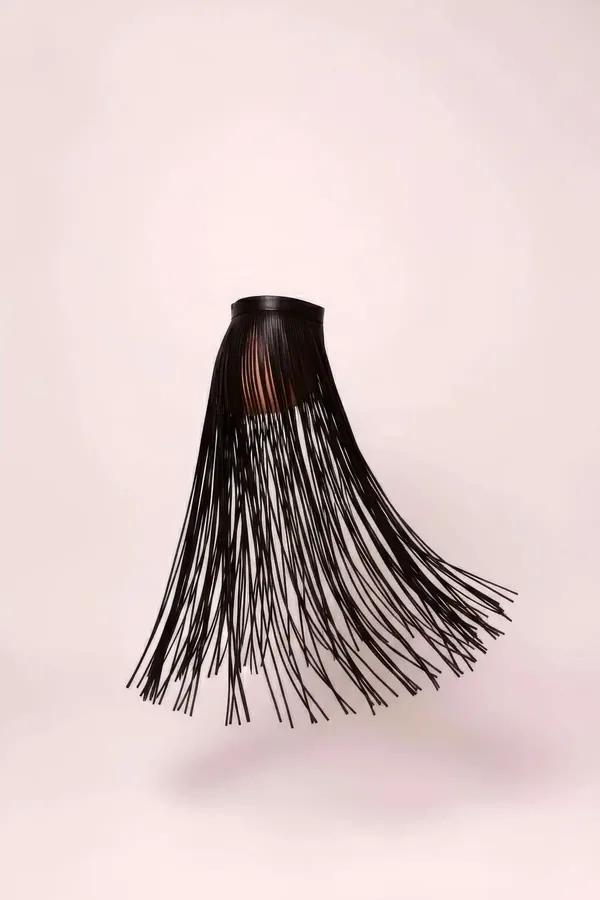 Black faux leather fringe waist skirt with dense long strands and structured high waistband, front view