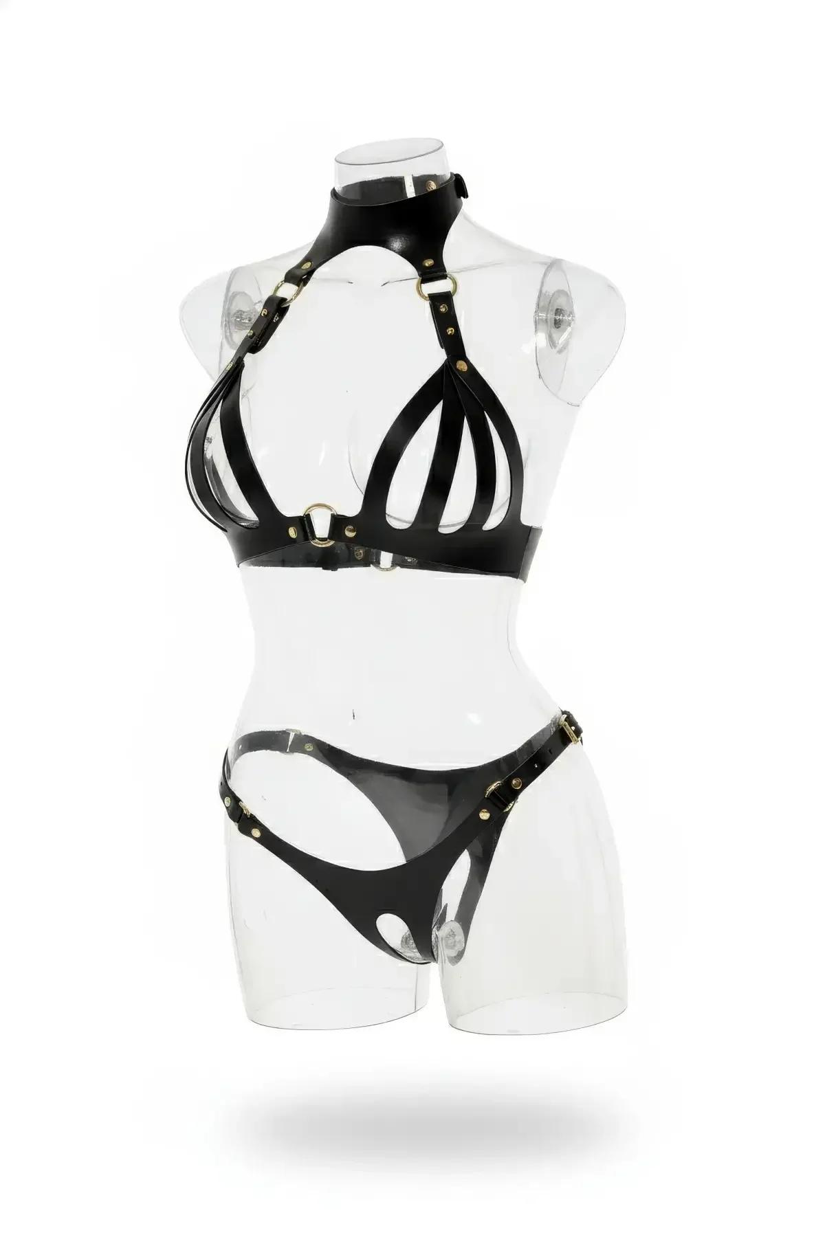 Black faux leather caged bra and panty harness set with gold-tone O-ring and buckle hardware on mannequin