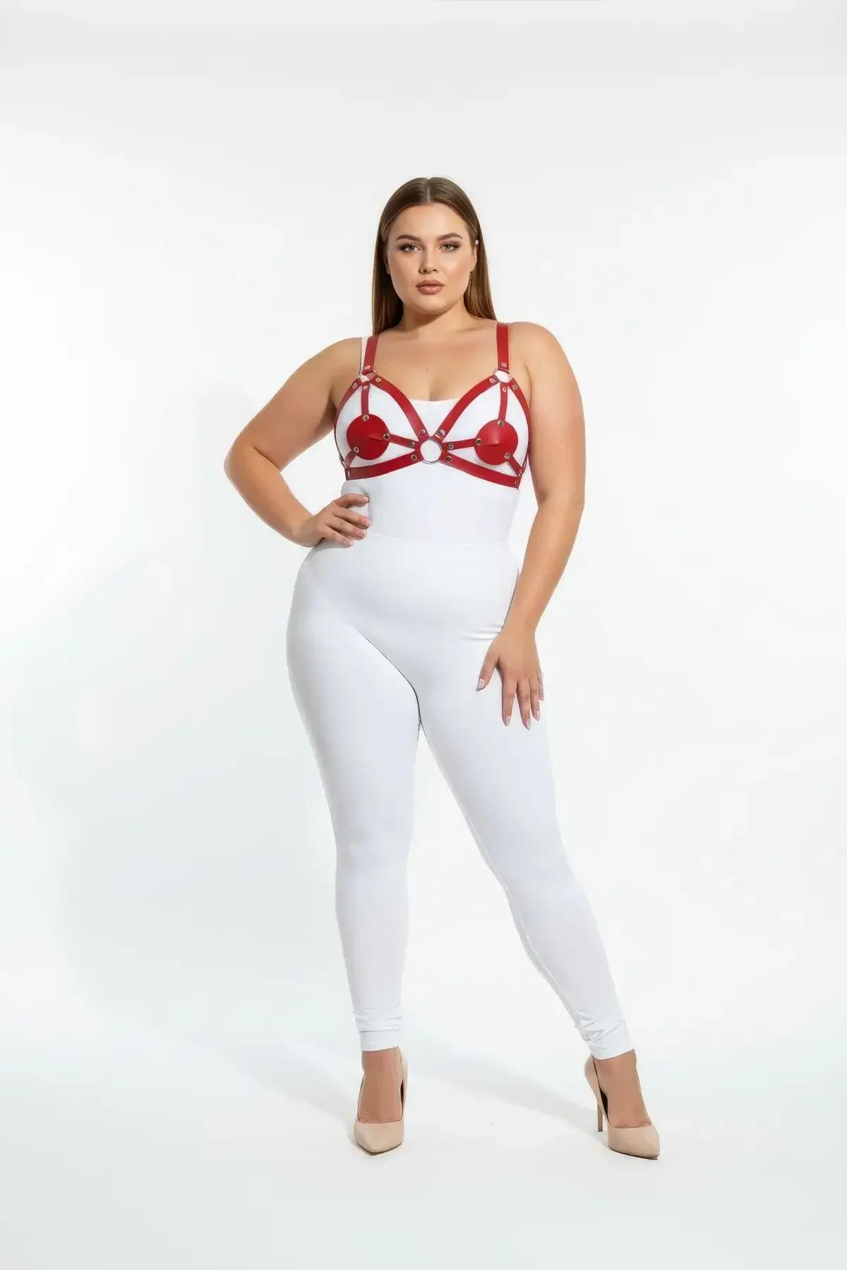Close-up of red strappy harness raised heart panels and chrome hardware