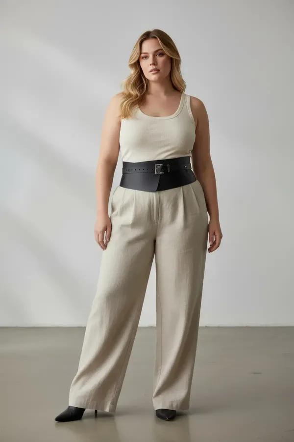 black faux leather wide corset belt with silver rectangular buckle worn at natural waist over pleated skirt