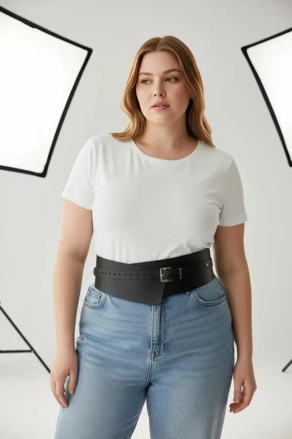 black faux leather wide corset belt with silver rectangular buckle worn at natural waist over pleated skirt
