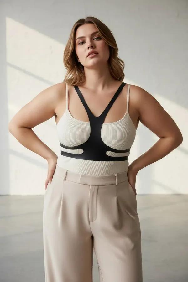 black faux leather chest harness overlay with V-front straps and dual waist bands worn over white tank top