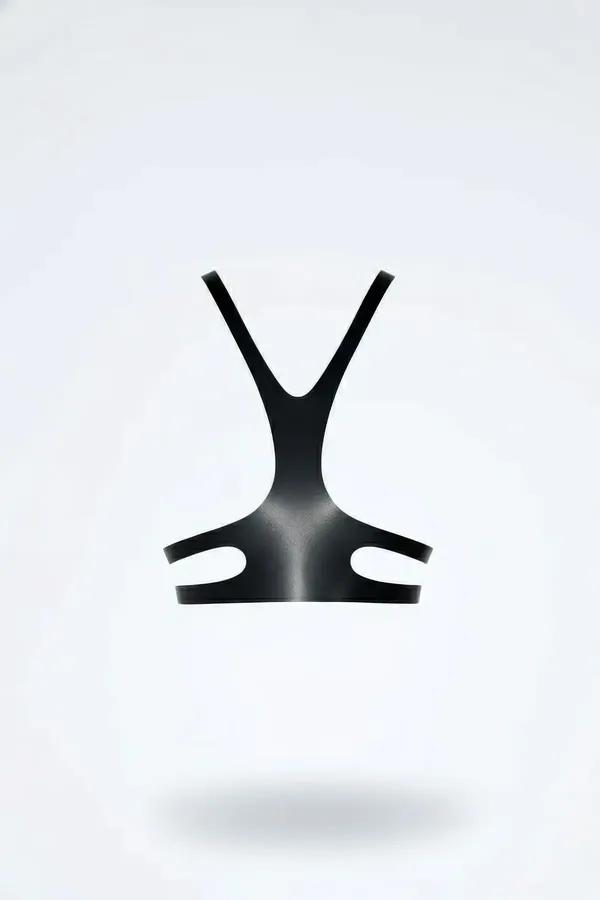 Black faux leather Y-strap harness top with open waist cutouts and no metal hardware, front view on white background