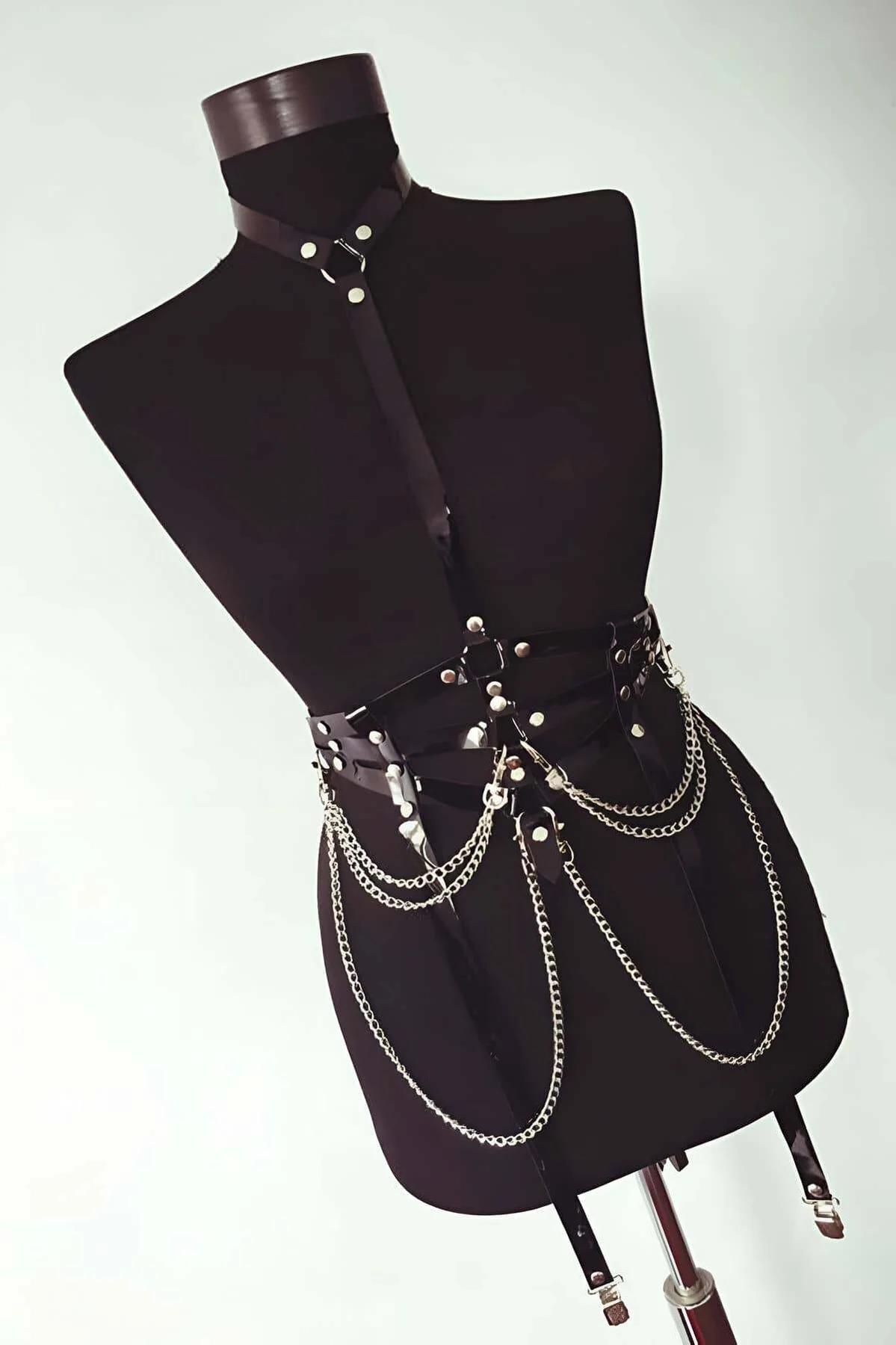 Black chest harness with three swag gold chains styled with micro skirt and thigh-highs