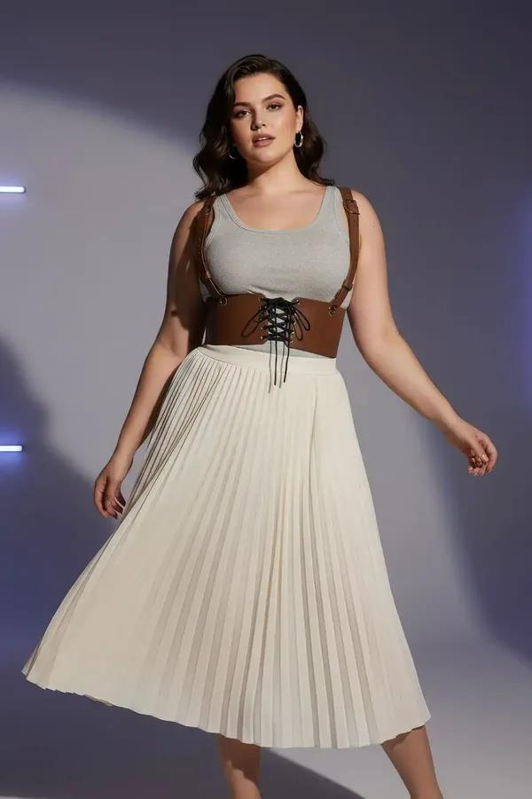 tan faux leather underbust corset harness belt with black lace-up front and gold shoulder buckles worn over white tank top