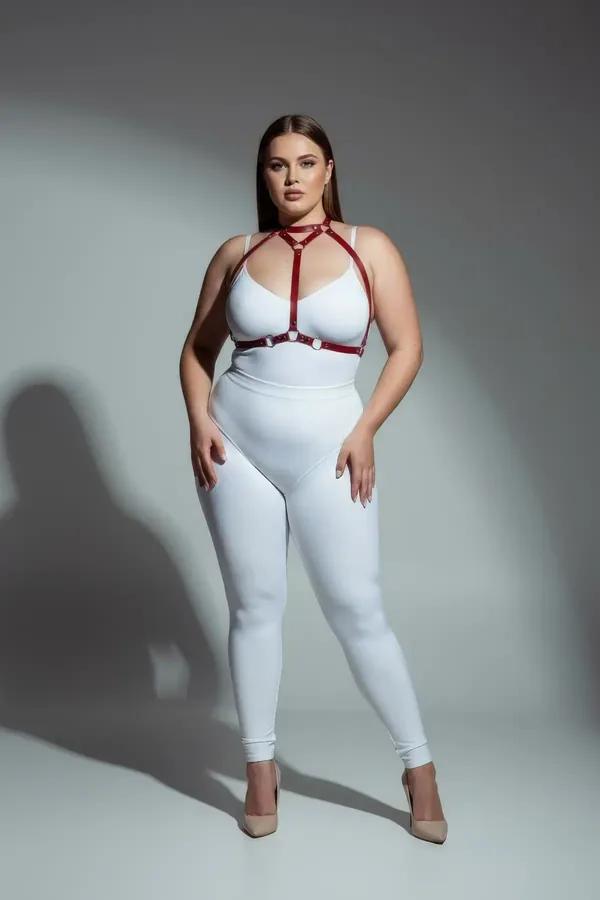 red faux leather strappy body harness with silver O-ring center, cage-style chest strap configuration