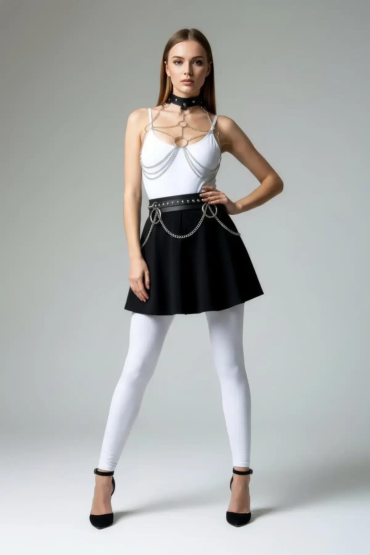 black faux leather O-ring waist belt with silver chain swag and grommet detail at hip