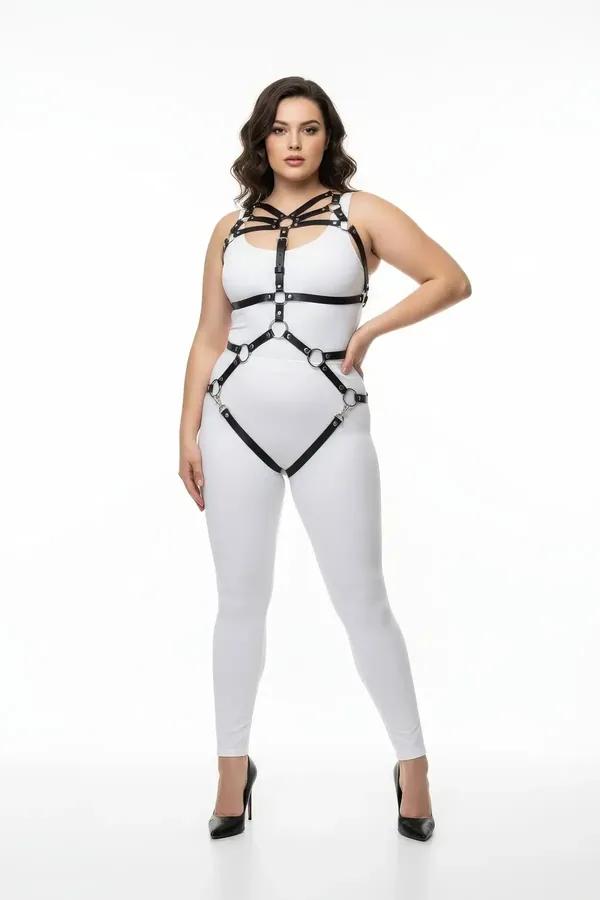 black faux leather full body harness with five silver O-rings worn over white bodysuit plus size model
