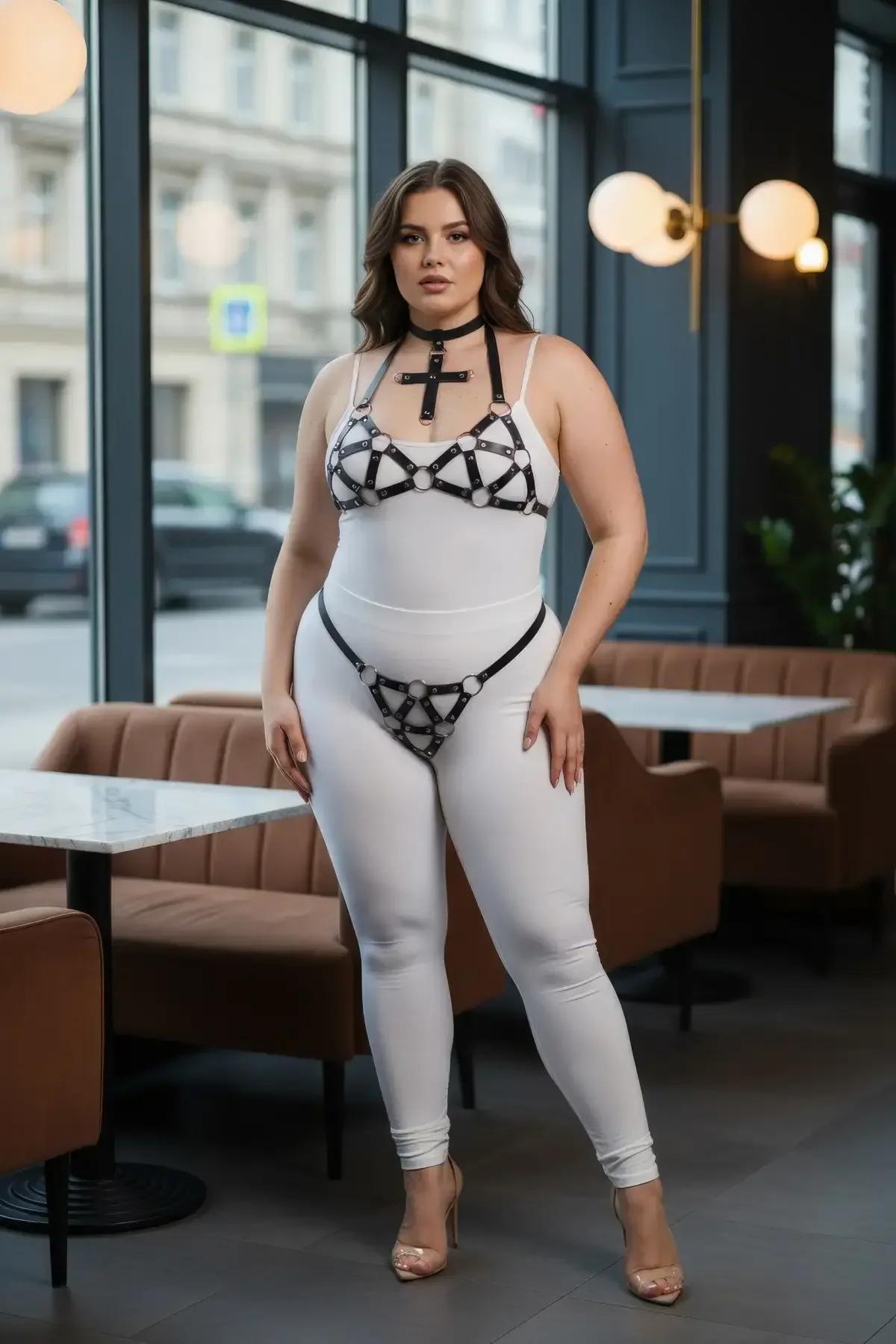 Full set view of black faux leather cross choker, bust harness, and hip harness laid flat showing all three pieces