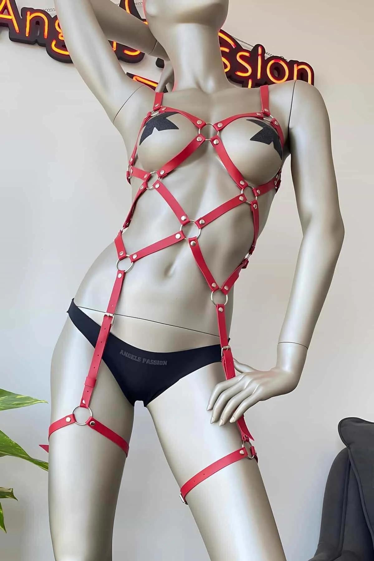 Red faux leather caged full body harness with silver O-rings on chest waist and thigh straps on mannequin