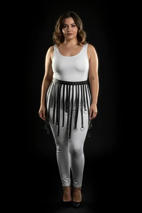 black faux leather skirt harness with cascading vertical straps and silver O-rings worn over white leggings