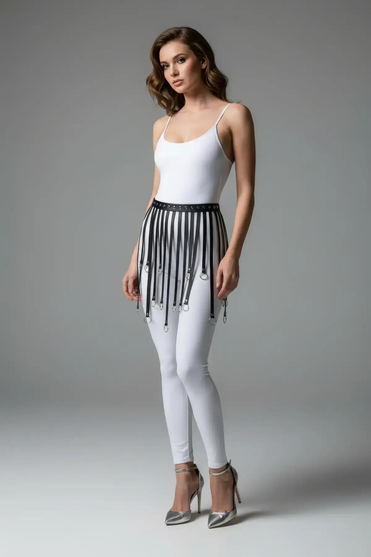 Black faux leather fringe skirt layered over bodysuit, full-length side profile view