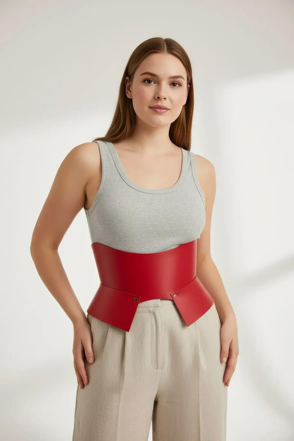 claret red waist cincher belt styled with beige wide-leg trousers and tank top