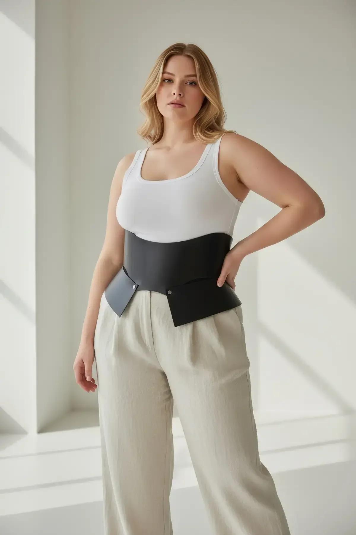 black matte vegan leather wide waist cincher belt front panel detail showing snap button closure