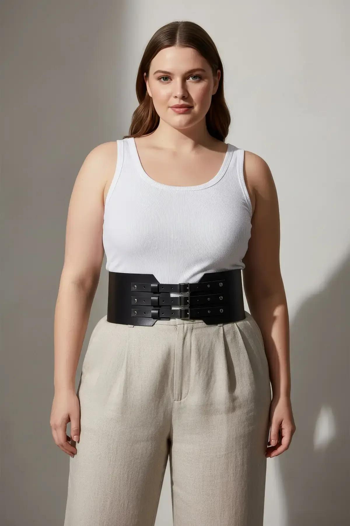 back view of black faux leather wide waist harness showing adjustable strap and textile lining