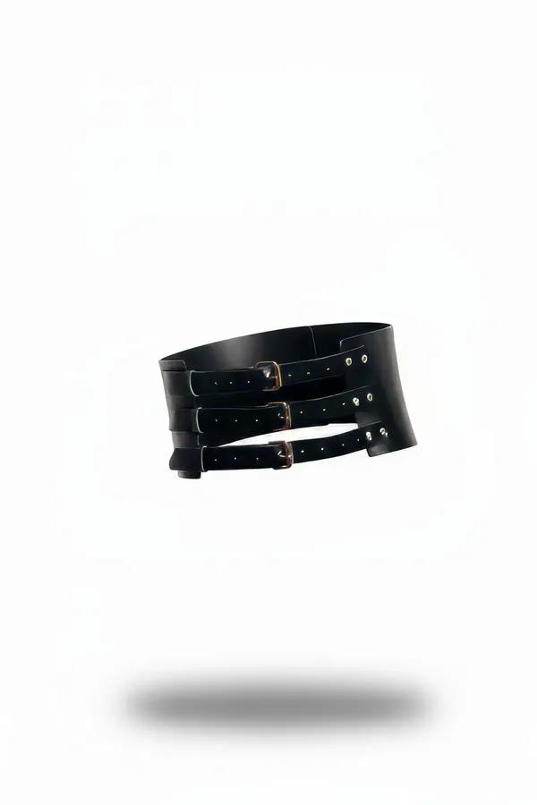 black faux leather waspie belt with three gold-tone adjustable buckle straps stacked vertically on wide structured panel
