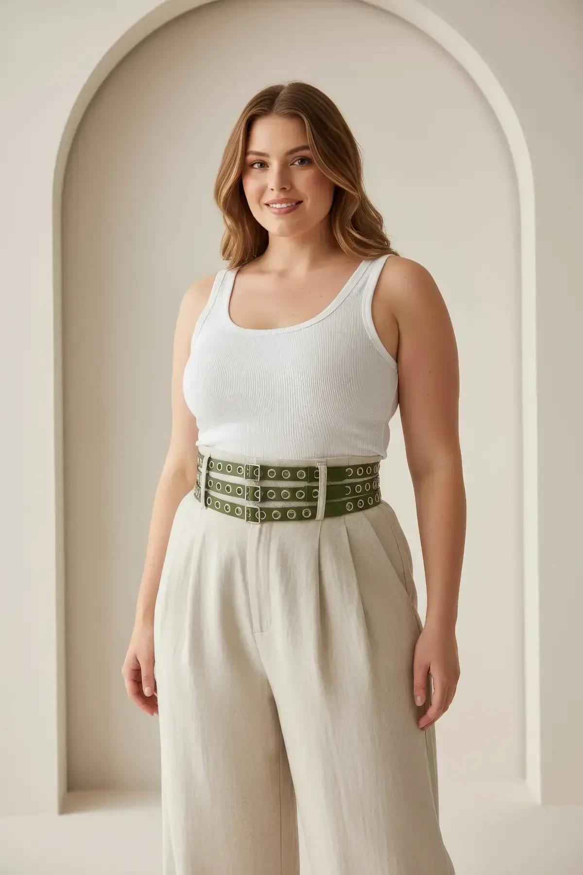 Close-up of three silver eyelet rows on wide khaki faux leather waist harness belt