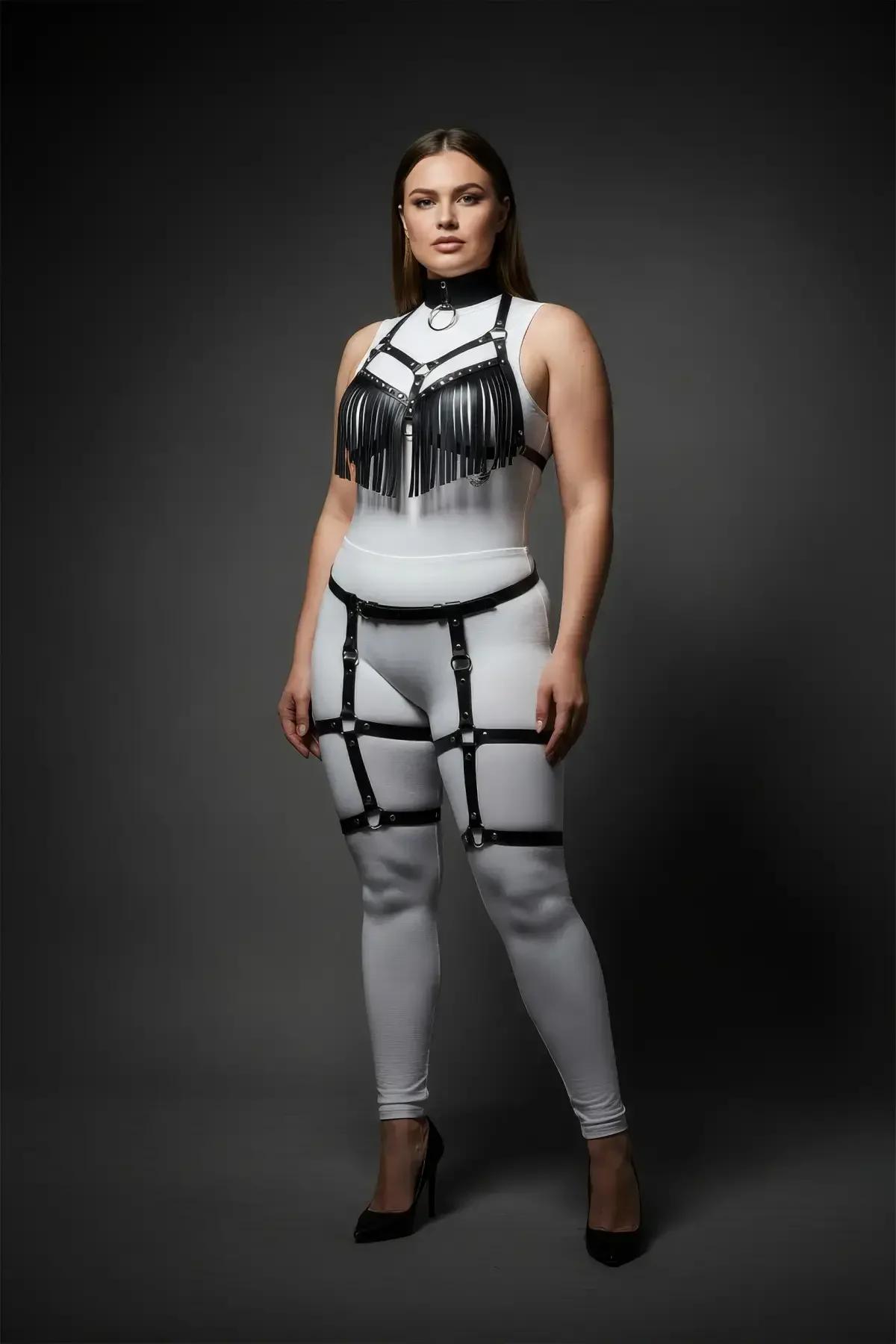 two-piece black fringed harness set styled over white bodysuit festival outfit