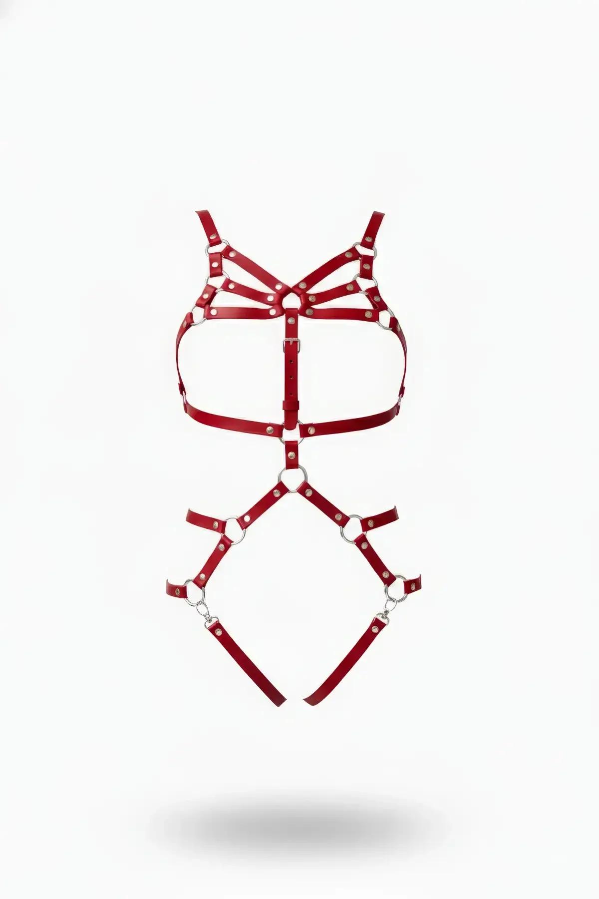 red faux leather full body harness with silver O-rings, triple chest cage straps, and garter leg frame on white background