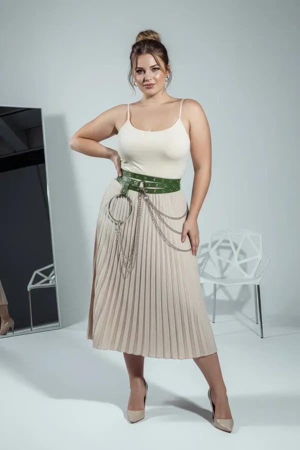 Wide green vegan leather grommet belt with silver O-ring chain drape worn at natural waist over cream wide-leg trousers