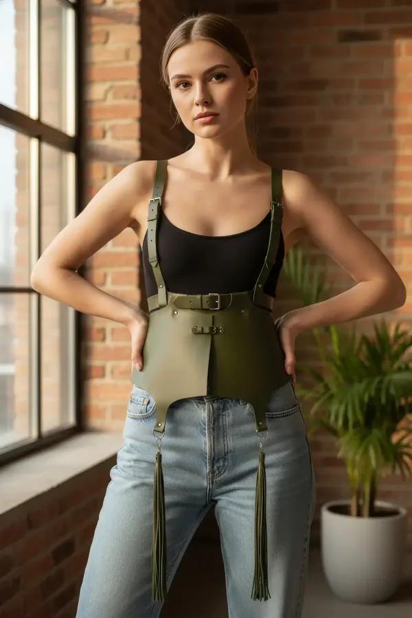 olive faux leather peplum waist cincher with tassels and adjustable shoulder straps styled over black crop top and jeans