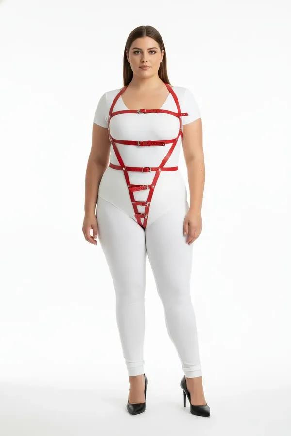red faux leather body harness with geometric cage straps and silver buckles worn over white bodysuit plus-size model
