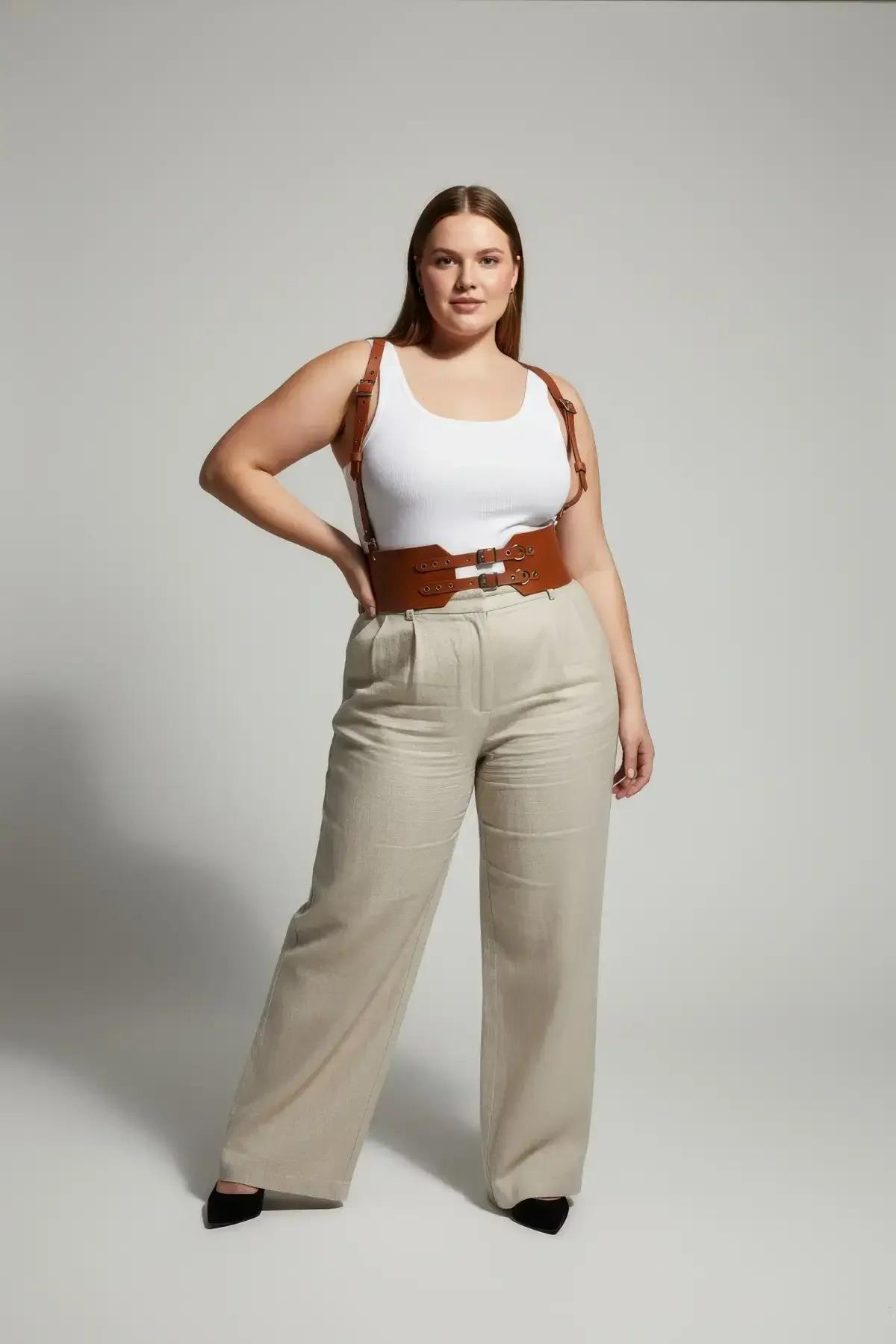 wide tan waist cincher harness layered over white top with wide-leg trousers
