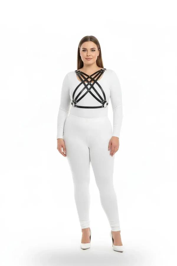 black faux leather chest harness with four crisscross diagonal straps and silver-tone studs worn over white outfit