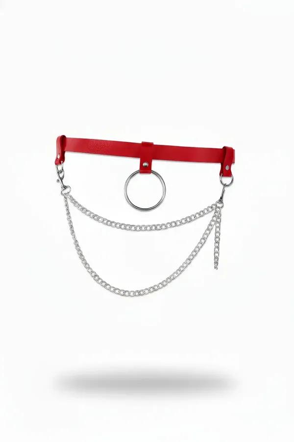 Red faux leather waist harness with central silver O-ring and two draped silver link chains on white background