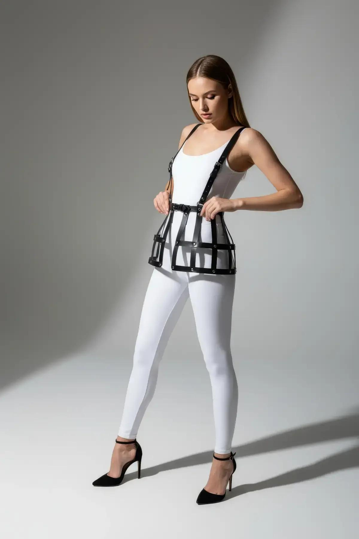 Close-up of silver-tone buckle and 1.2 cm wide faux leather shoulder strap on black cage skirt harness