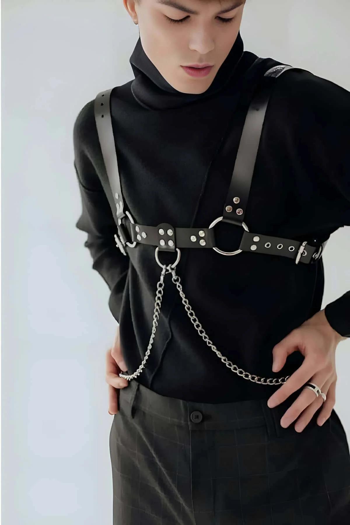 full body harness worn layered over fitted black top showing shoulder-to-waist strap configuration