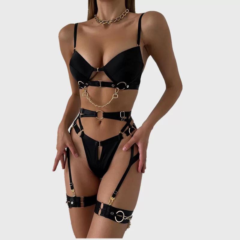 Black underwired 4-piece bra set with gold metal chain detail, O-ring hardware, waist belt, and leg garter bands