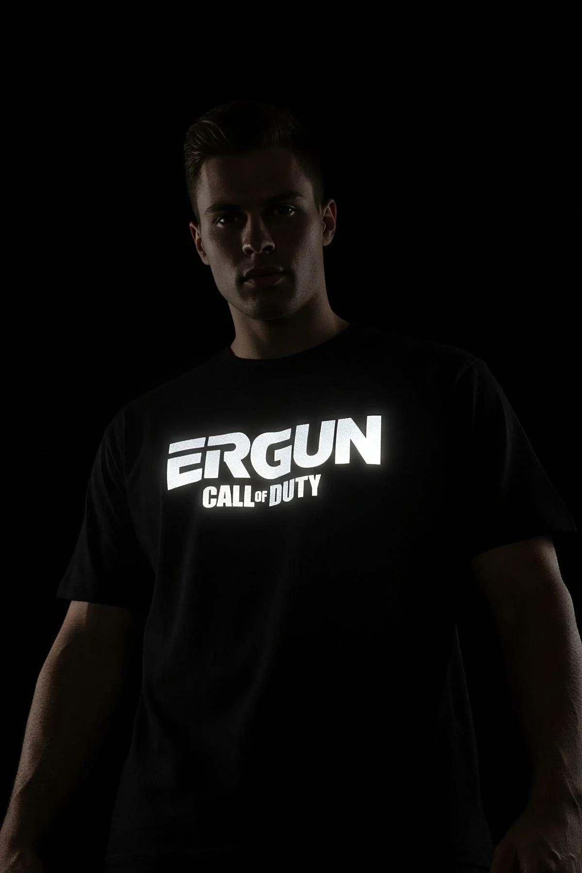 black reflective custom text t-shirt with bright white retroreflective print glowing under direct light on male model