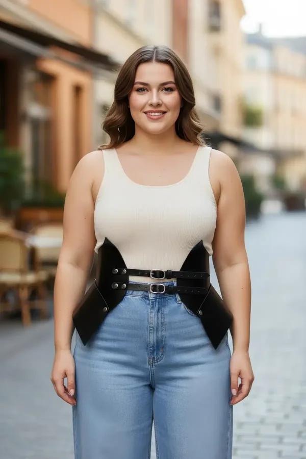 black faux leather waist cinch harness with wide structured panels and silver double buckle worn over cream top