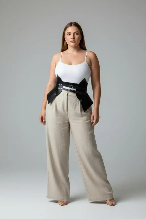 black faux leather waist cinch harness with wide structured panels and silver double buckle worn over cream top
