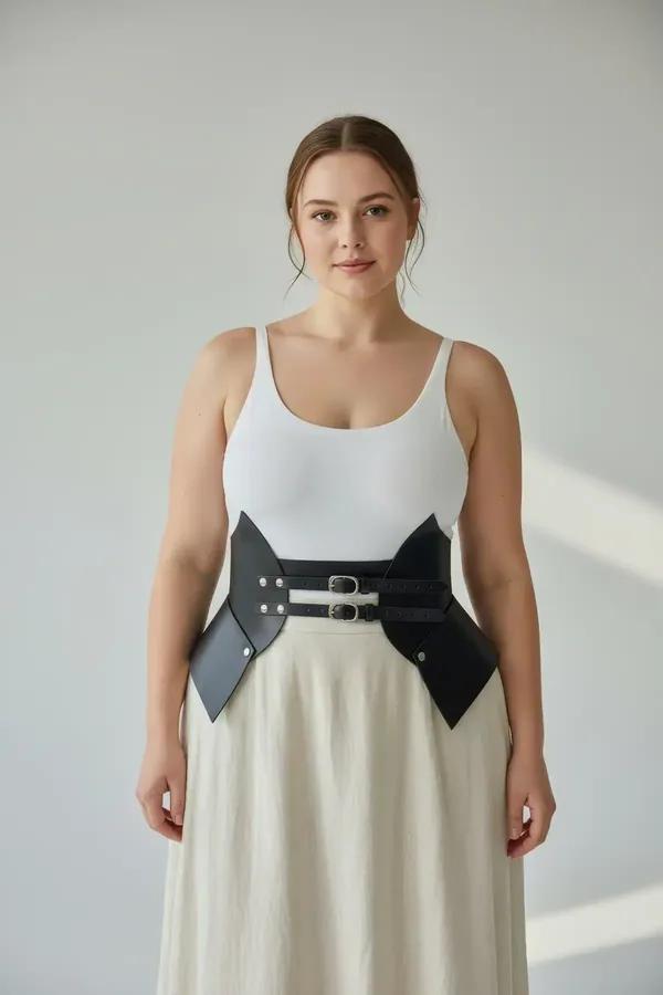 black faux leather waist cinch harness with wide structured panels and silver double buckle worn over cream top