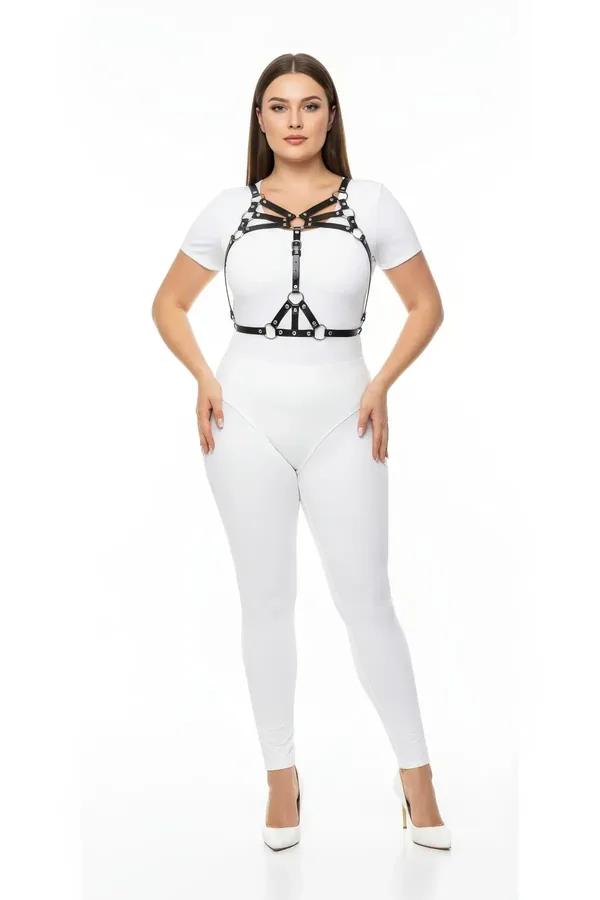 black faux leather strappy chest harness with silver O-rings worn over white bodysuit plus size model