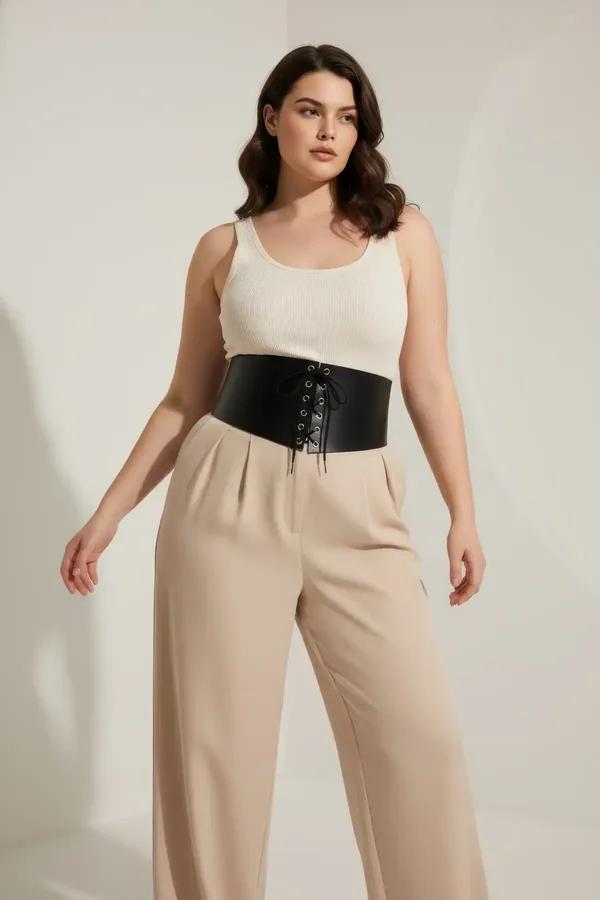 black faux leather wide underbust waist cincher with silver lace-up front eyelets and side buckle straps worn over cream cami