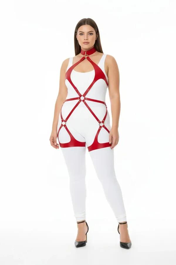 Red faux leather full body harness with gold O-ring details spanning neck to thigh on a plus-size model over white outfit